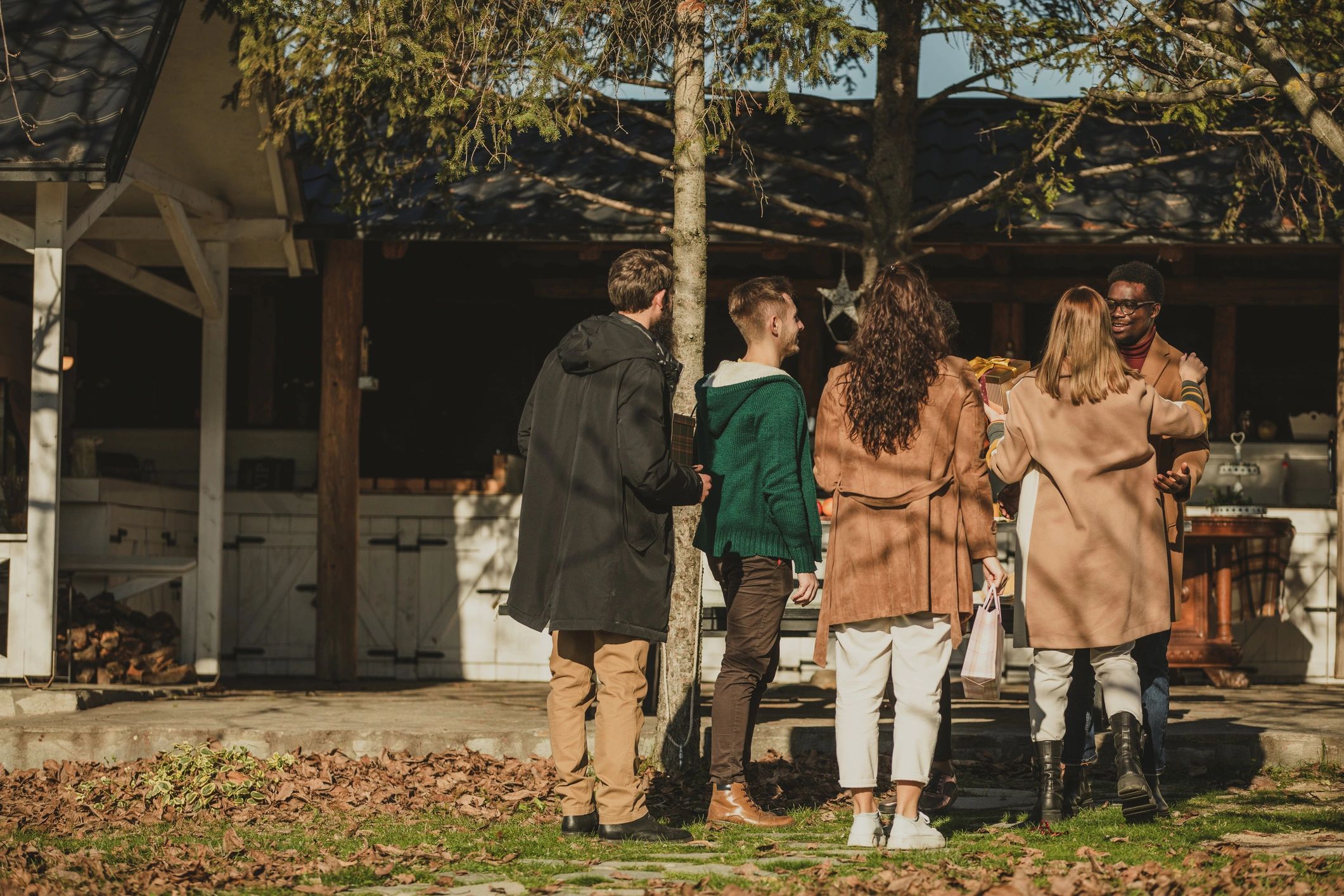 Extended family gathering outside a luxury home